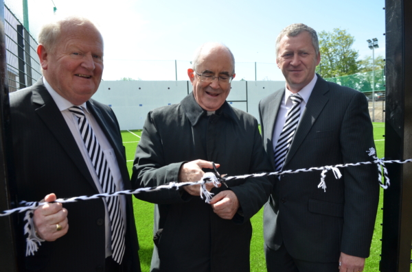 Open for business...Monsignor Donnelly, watched by Club Omagh Chairman Seamus Hannigan and St. Enda's Executive Committee Chairman John McElholm, cuts the ribbon to officially open the new Ball Wall and 4G training area at Healy Park. The new facility which has taken just six months to complete, is the third new development project at St. Enda's with our Club Omagh fund-raising committee instrumental in raising necessary funds for work at the club. Earlier projects included the re-opening of St. Patrick's Park and the Club Gym at Healy Park. Many thanks to all the Club Omagh members whose financial contribution has been key to the work at the club.