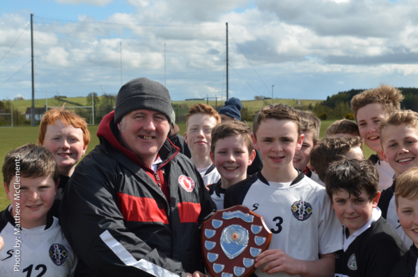 St. Enda's captain Paul Donnelly receives the Tyrone Feile shield