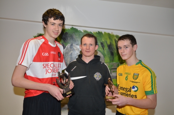 U16 manager Kevin Cunningham presents the 2014 U16 hurling player of the year award to Ciaran Lagan while Ciaran McDermott receives the Most Promising award.
